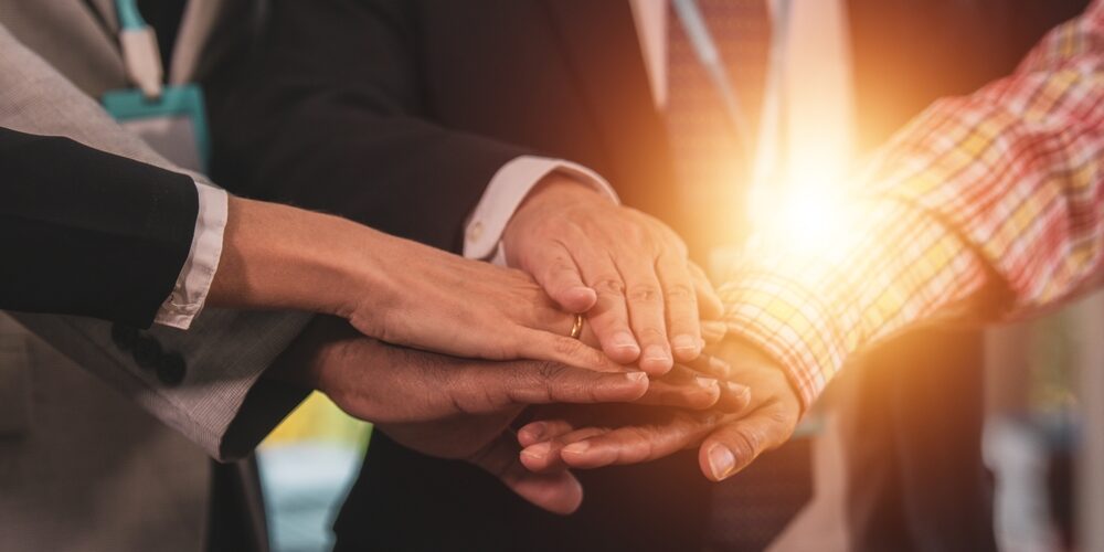 Business,Team,People,With,Joined,Hands,As,A,Team